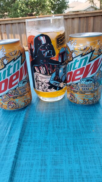 MTN Dew cans along with a designer glass