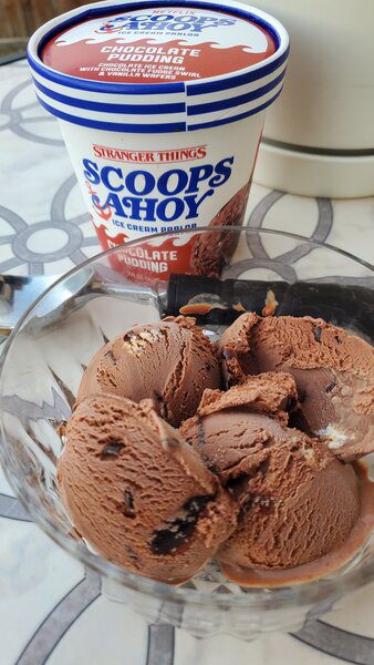 A bowl of ice cream sitting on a table.