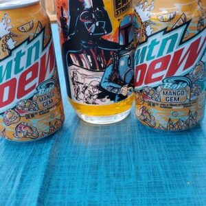 MTN Dew cans along with a designer glass